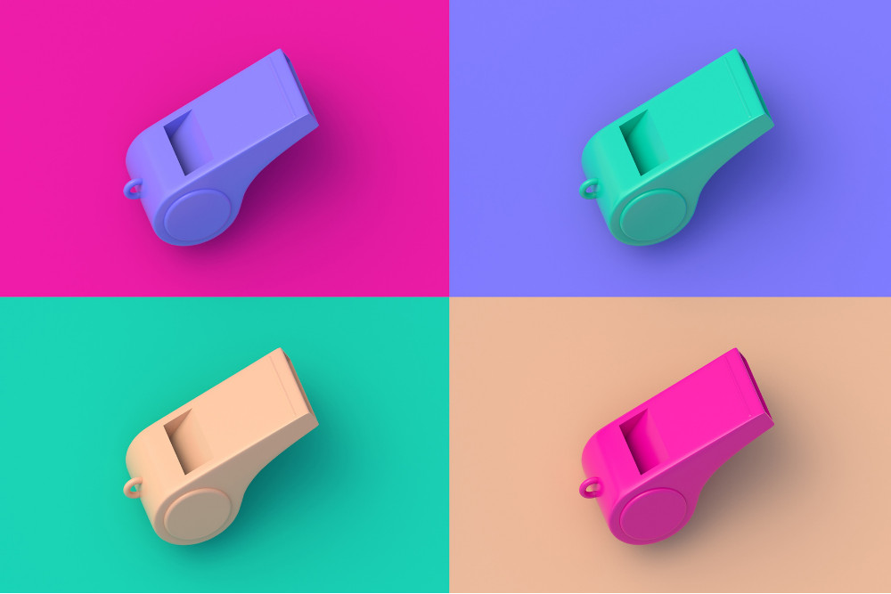 Set of four different coloured, 3D-rendered whistles on colourful segmental background.