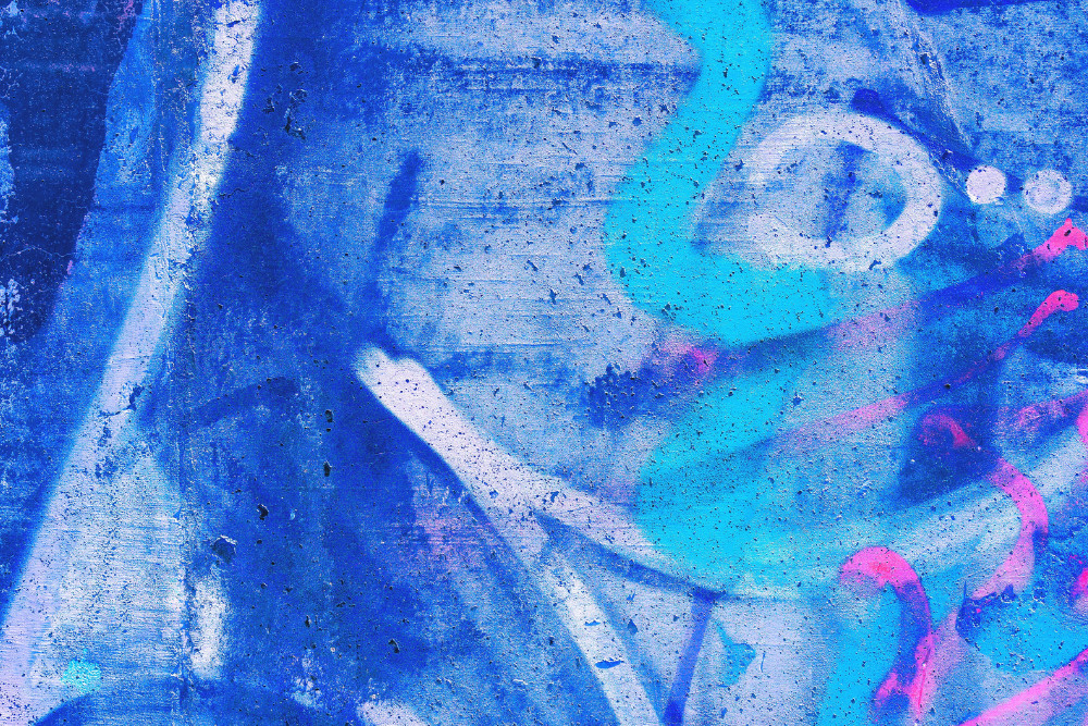 Closeup of colorful pink, purple, blue urban wall texture. Modern pattern for wallpaper design. Creative modern urban city background for advertising mockups. Grunge messy street style background.